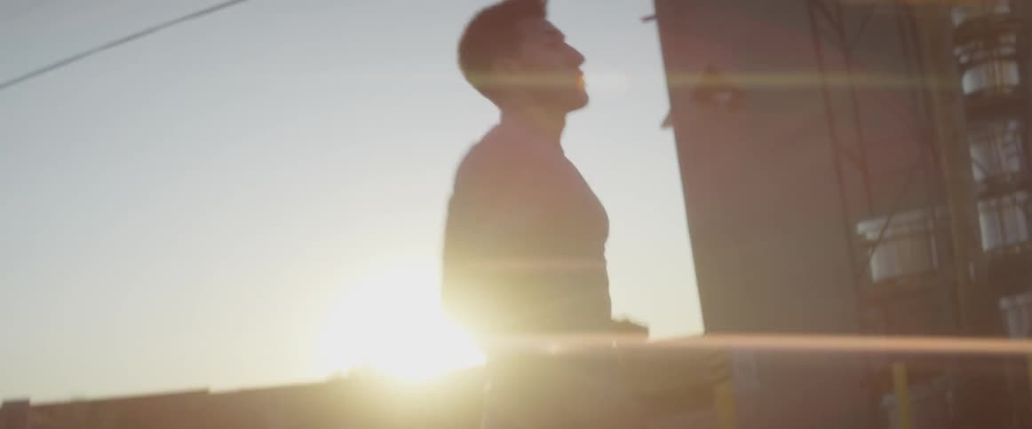 A man is jogging in place as the sun sets
