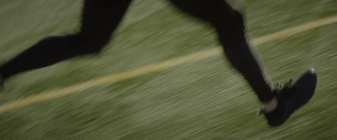 A man is racing across the field