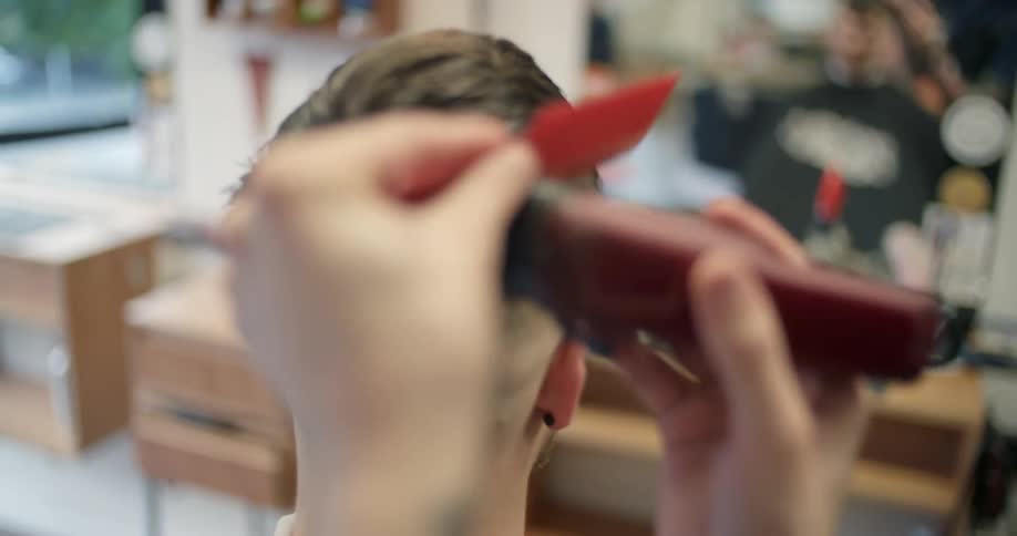 Man sitting and getting a haircut