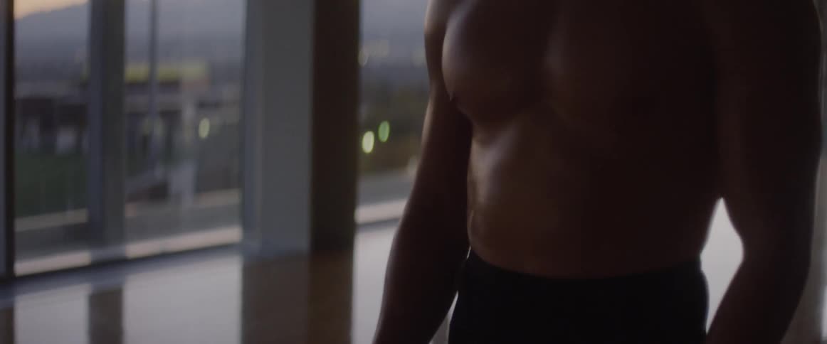 A male dancer warms up in a studio at sunset