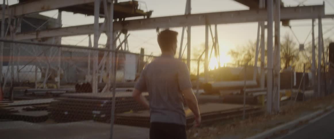 Man stretches and exercises outside at sunset