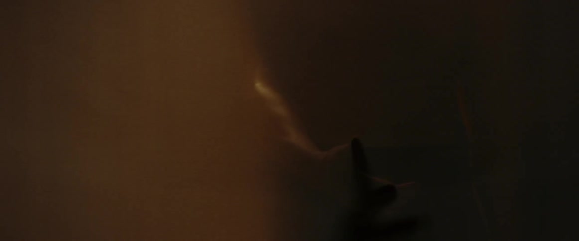 A person waves his arms around in the foggy room