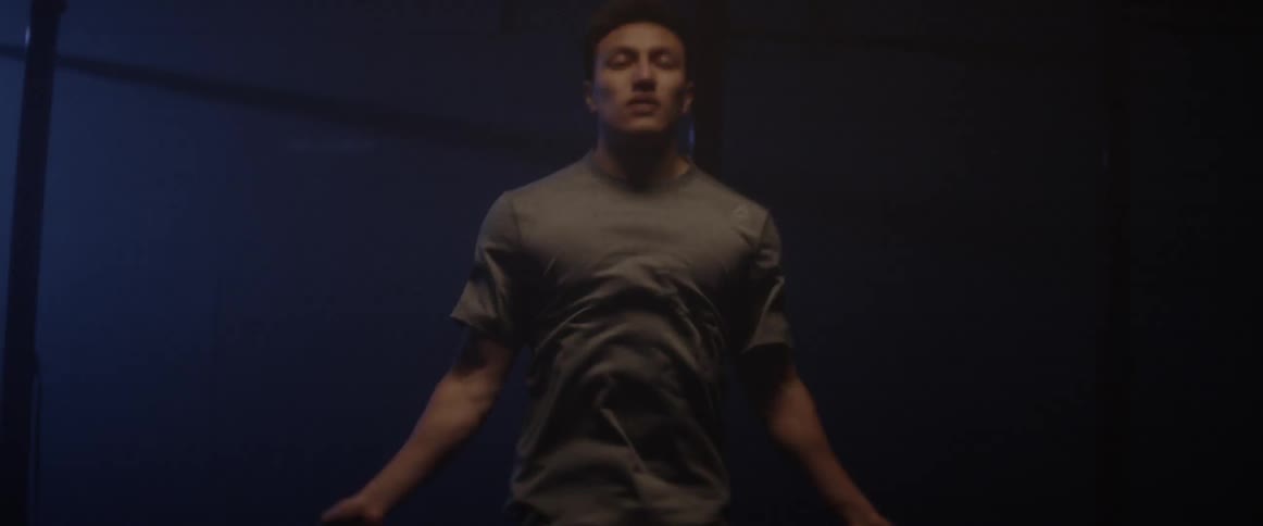 Man jumps rope in a dark gym