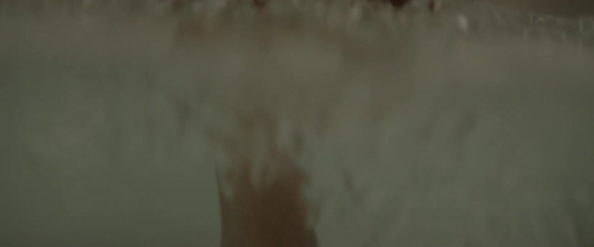 Man climbs into a bathtub with icy water