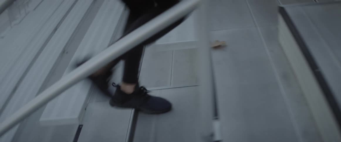 A man runs up bleacher steps