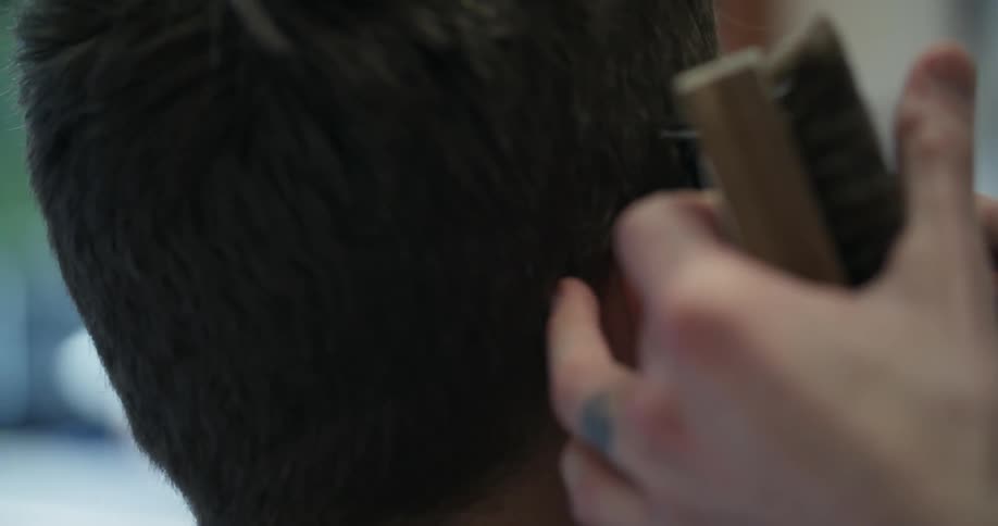 Person clipping a man's hair