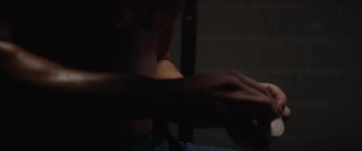 Man wraps his wrists with athletic tape