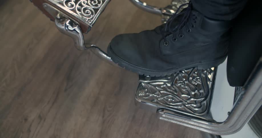 A man is sitting in a barber chair