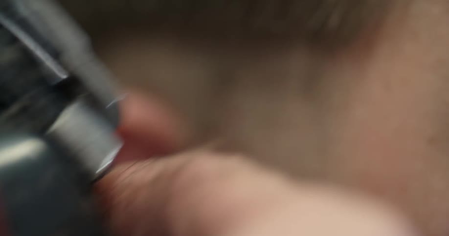 Man getting his hair cut with a razor