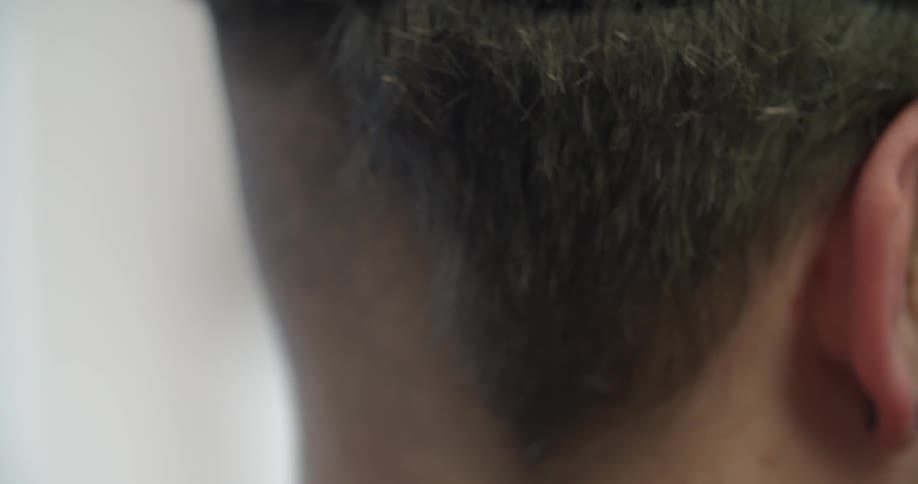 A man is getting a hair cut