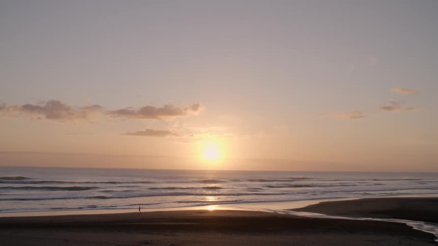 View of a beach at sunset from a distance