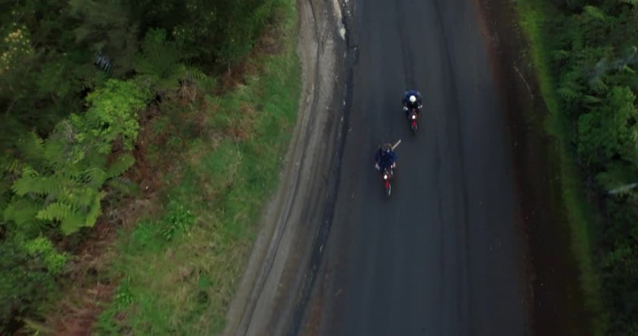 Two motorcycles speeding down the highway