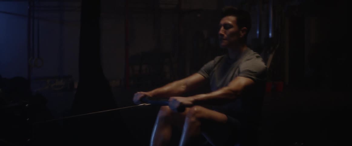 A man is exercising in the dark