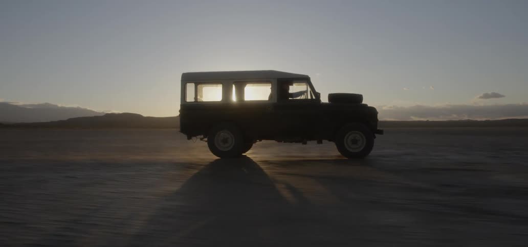 The truck moves fast over the flat field