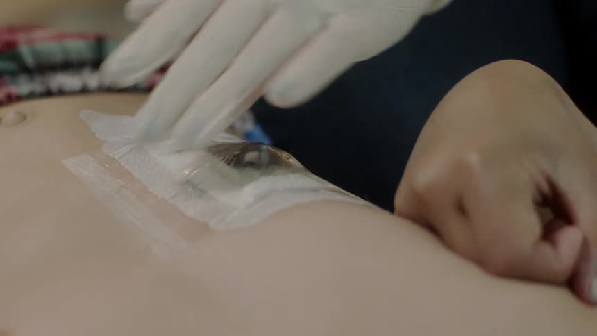 A medical professional bandages a patient