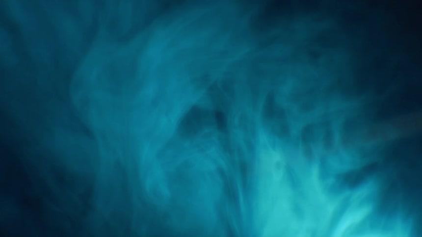 Smokey haze floating in the air lit up by blue light