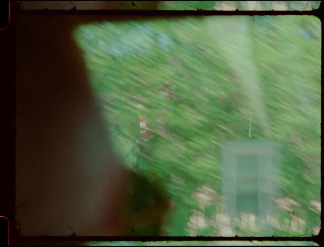 A car drives by an american flag