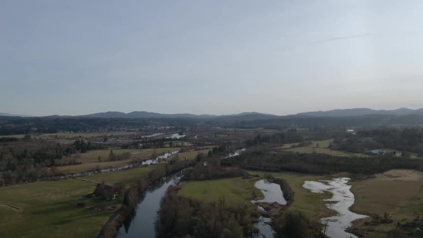 Flying above a fertile river valley landscape