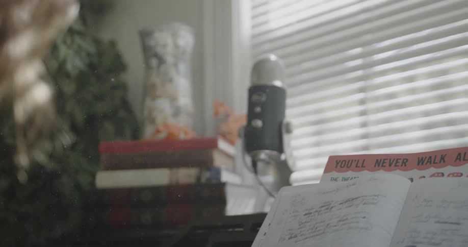 A woman is reading from a book on a piano