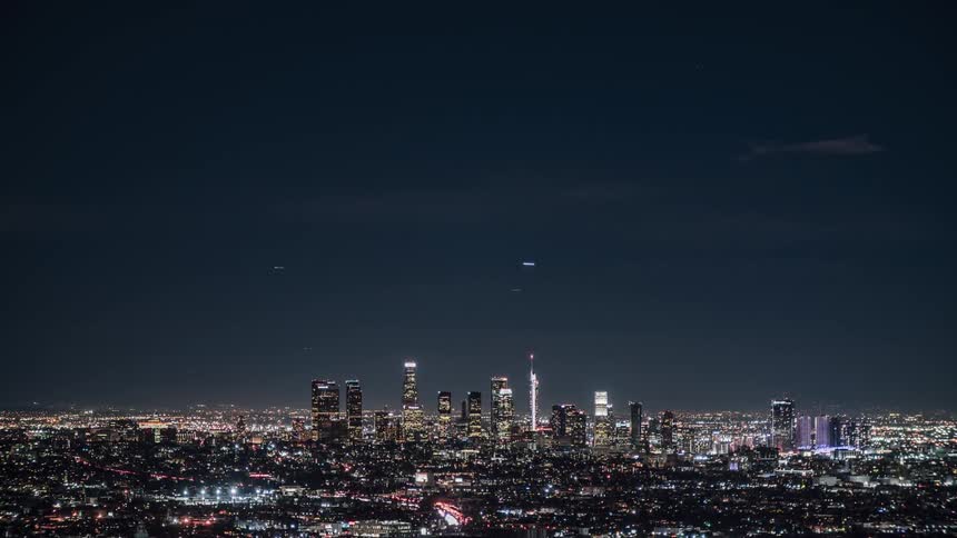 Lights from buildings and traffic shine in a city skyline at night