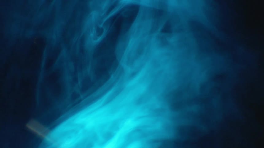 The smoke is swirling in a circle in the dark