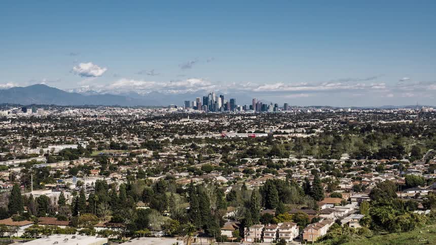 Clouds are drifting across a sprawling city throughout the day