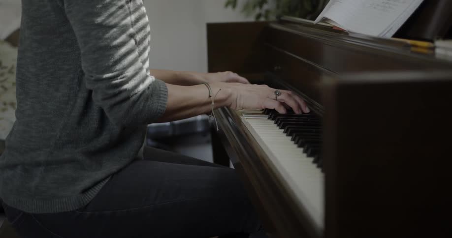 A woman plays a piano