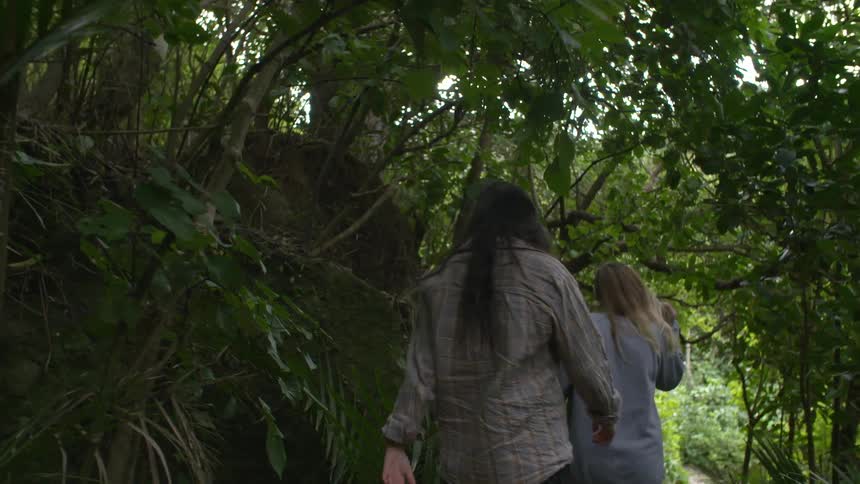 Two women walking in a forest