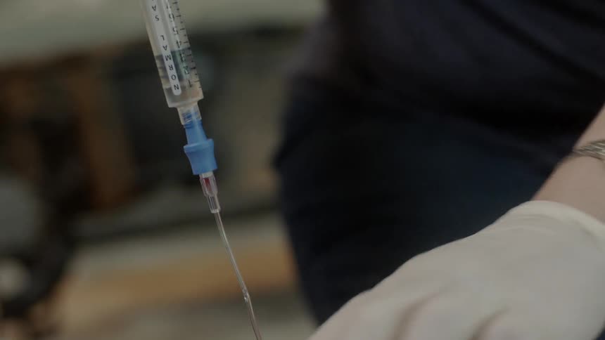 A medical worker administers medication