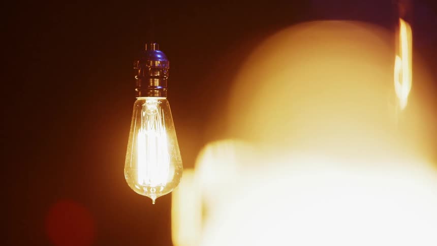 Light bulbs glow in a dark room