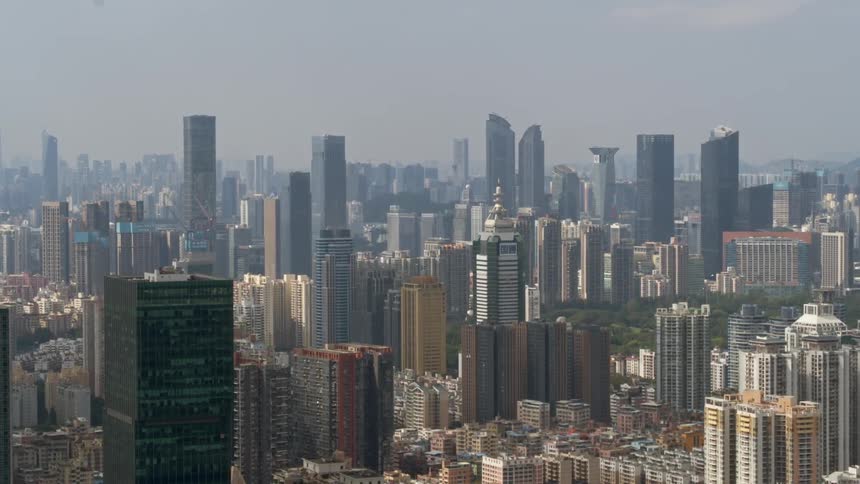 Skyscrapers and high rises in a city are standing tall on a hazy day