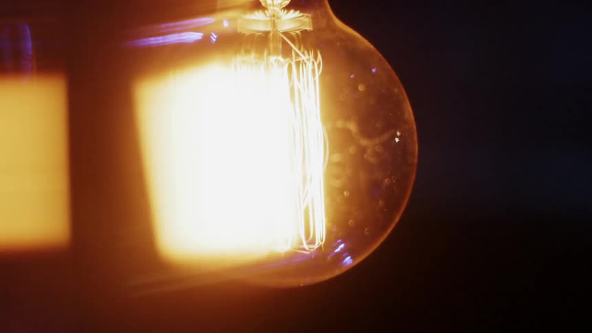 A light bulb glows in the dark