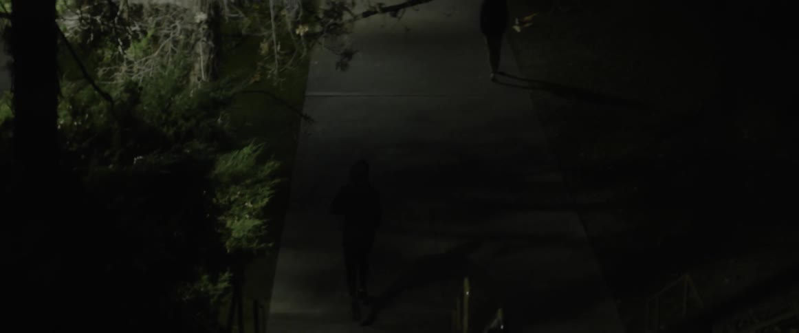 Man jogs on a city sidewalk at night