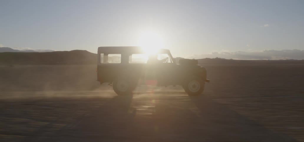 A truck drives fast over the desert