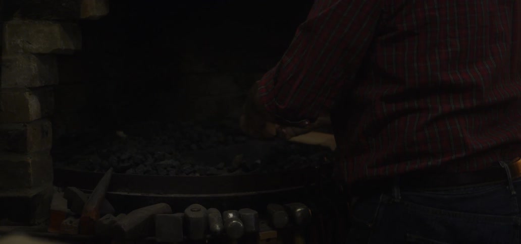 A man lights a match near a stove