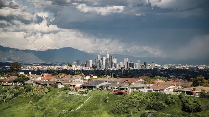 Clouds float over city skyscrapers