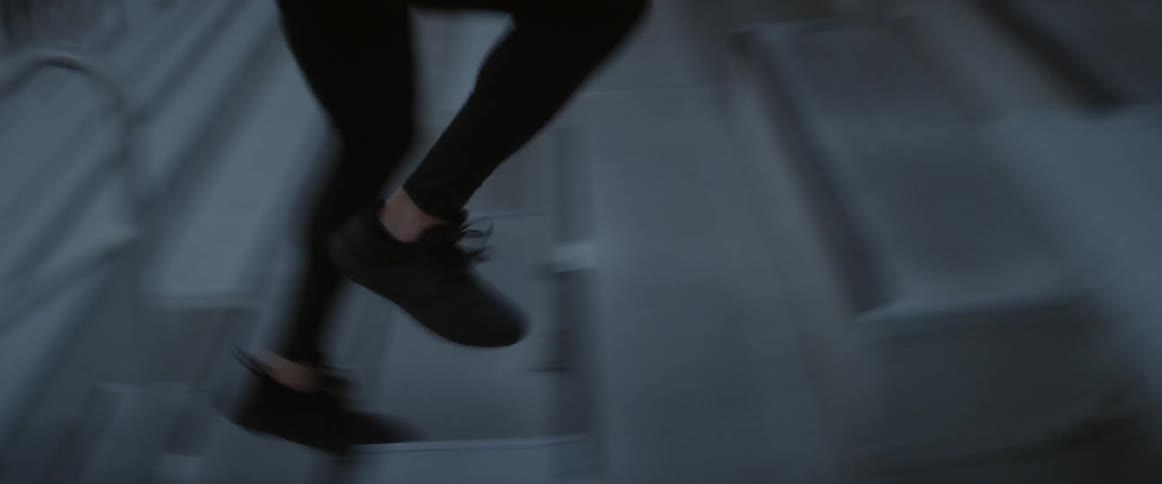 A man runs up bleachers