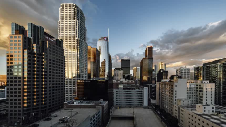 Clouds pass over a city then night falls