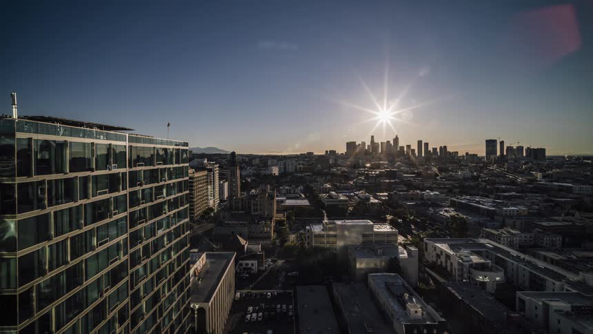 Sun rising over large city