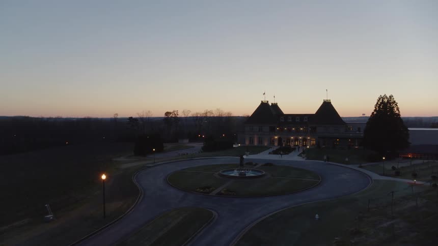 A slow traverse around the courtyard and circle drive in front of a vineyard pavilion at dusk