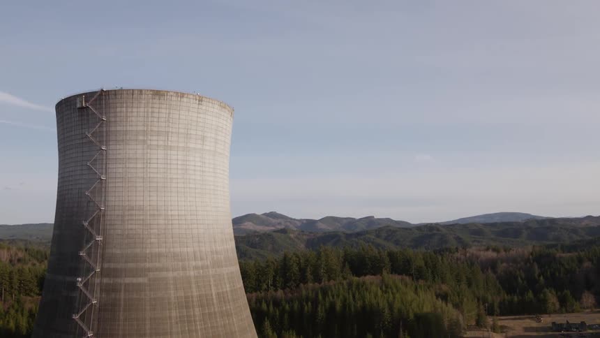 A nuclear power plant surrounded by forest and mountains