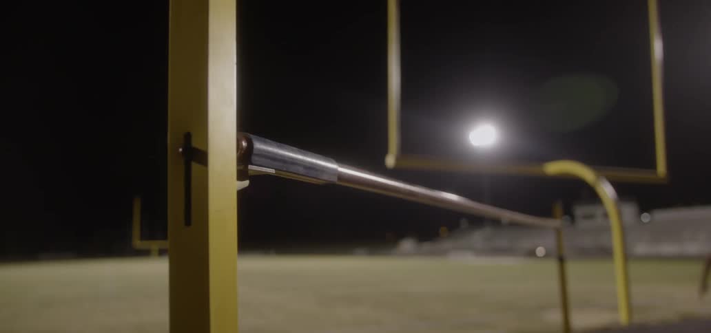 An athlete knocks the crossbar off when jumping over