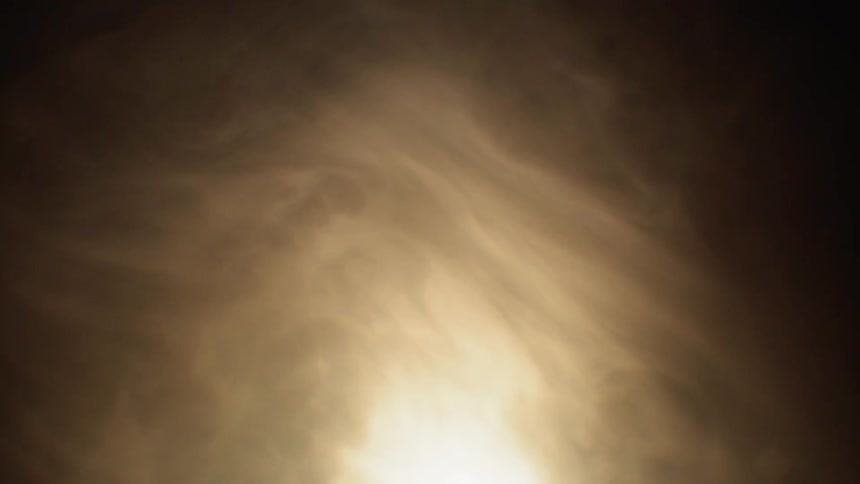 The smoke swirls around a light