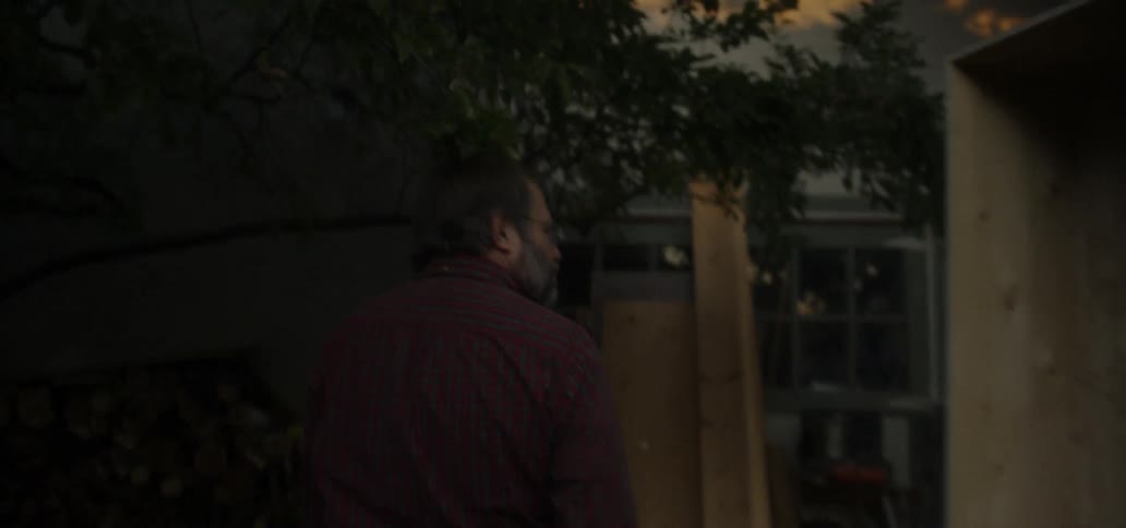 Man walks towards a house and enters