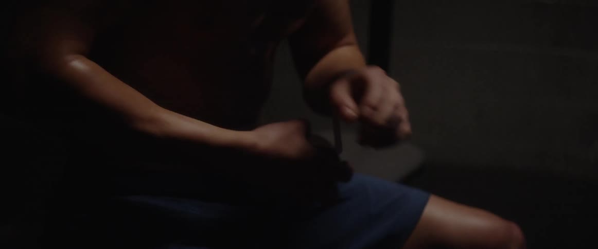 Man grabs roll of tape and tapes his left hand