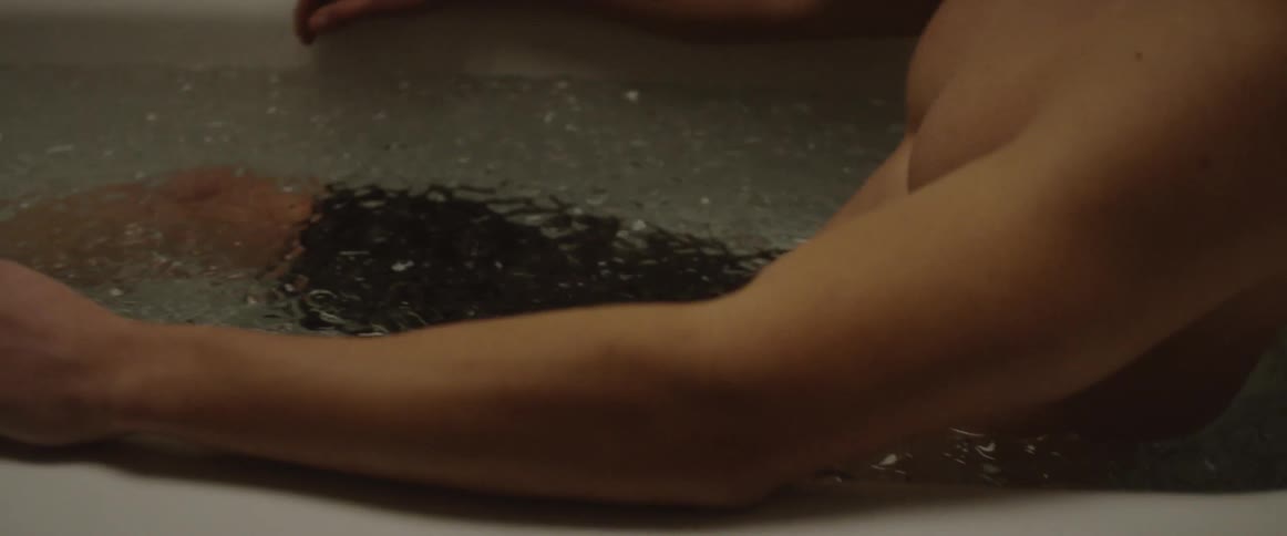 A man soaks in a tub full of ice and water