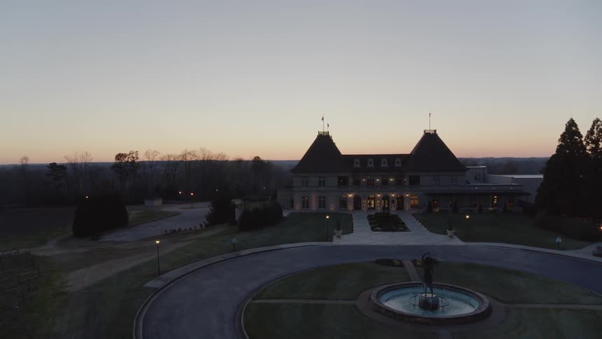 Slow descent to reveal the pavilion courtyard at the center of the vineyard
