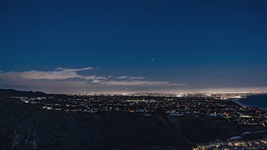 The city slowly lights up as it gets dark