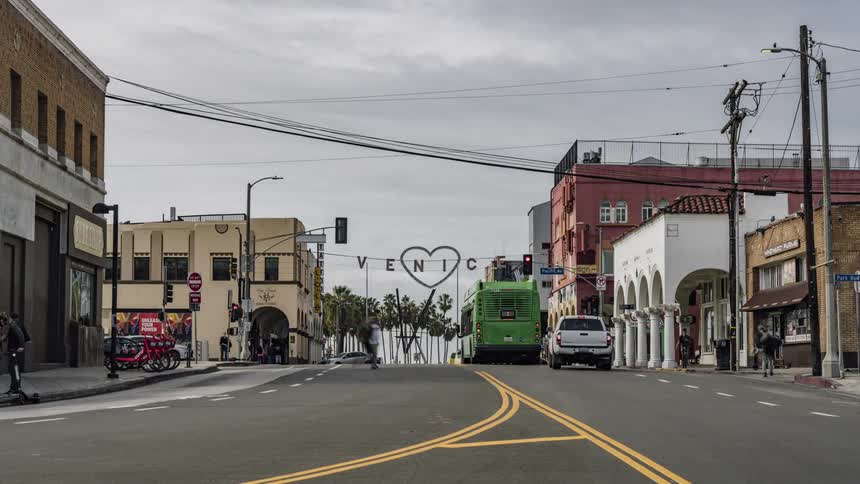 Cars drive on a city street