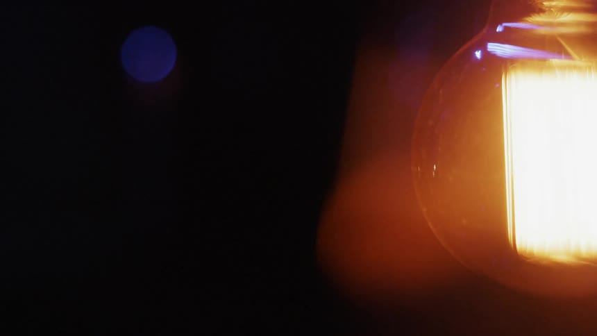 Electric coils light up inside glass globe